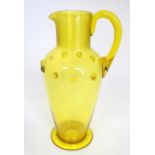 A Victorian yellow glass jug with punt decoration. Approx 10 1/4" high Please Note - we do not