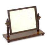 An early / mid 19thC mahogany toilet mirror with a rectangular adjustable mirror to the centre,