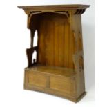 A c.1900 oak Arts & Crafts monks bench / hall stand produced by Goodyers of Regent St and Bond St.