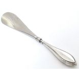 A silver handled shoe horn, hallmarked Birmingham 1909 Approx. 7" long Please Note - we do not