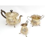A silver bachelor's tea set comprising teapot, twin handled sugar bowl and milk jug, hallmarked