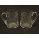 Two 19thC glass tankards with twist handles and engraved foliate decoration. One titled 'Mary',