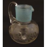 A Victorian water jug with engraved floral and foliate decoration and turquoise banding. Approx. 5