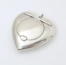 A small silver powder compact of heart shape. Hallmarked Birmingham 1917 maker Henry Williamson