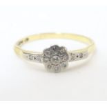 An 18ct gold ring with 12 platinum set diamonds. Ring size approx. Q Please Note - we do not make