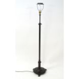 A 20thC lacquered brass standard lamp of adjustable on a circular three footed base. Approx. 60"