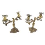 A pair of 19thC cast gilt metal twin branch candelabra / candelabrum decorated with scrolling