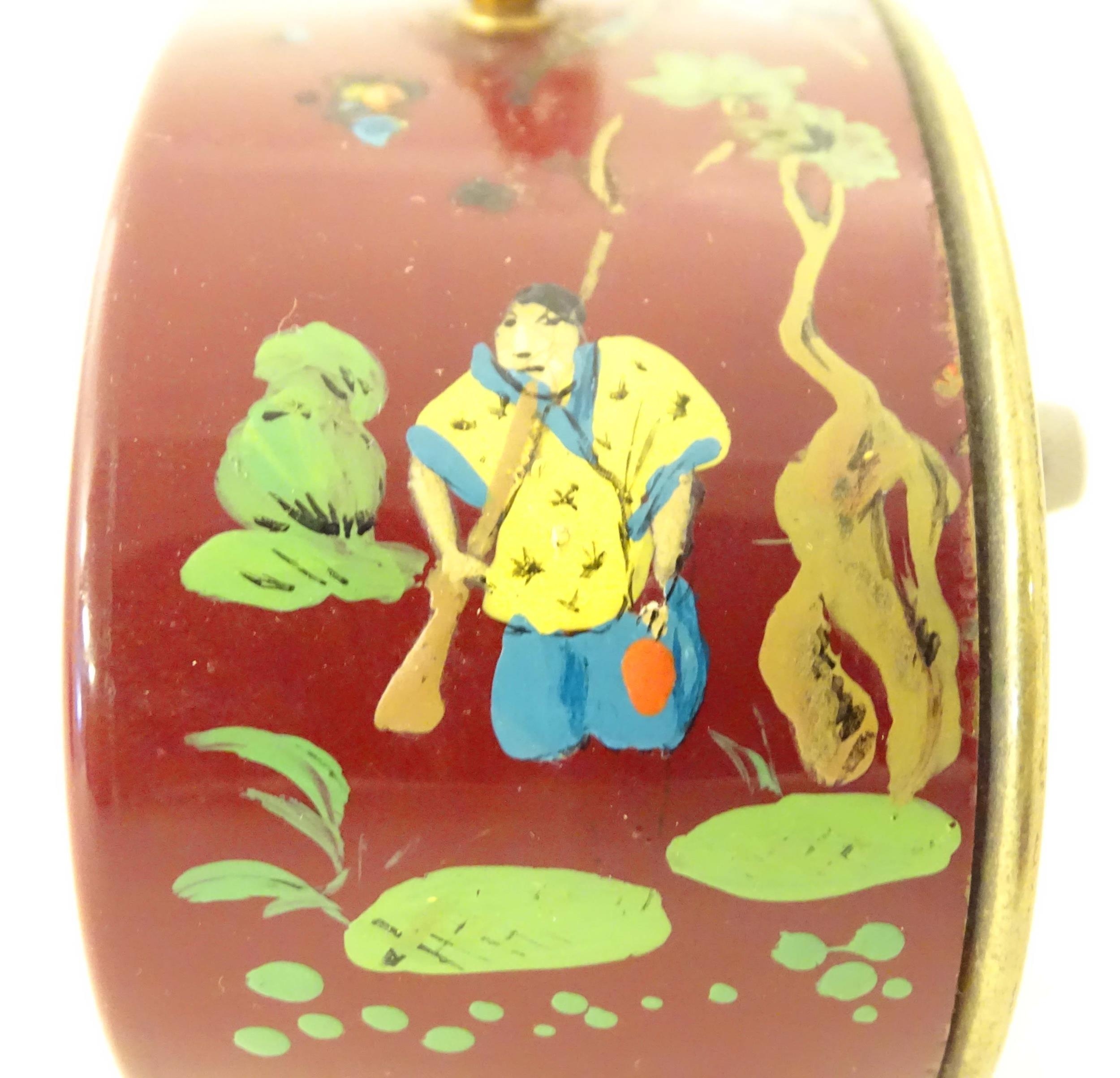 A 20thC French red lacquered travelling alarm clock with chinoiserie decoration. The dial signed - Image 7 of 12