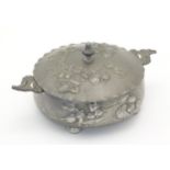 An Art Nouveau / Jugendstil twin handled pewter pot and cover with relief floral and foliage