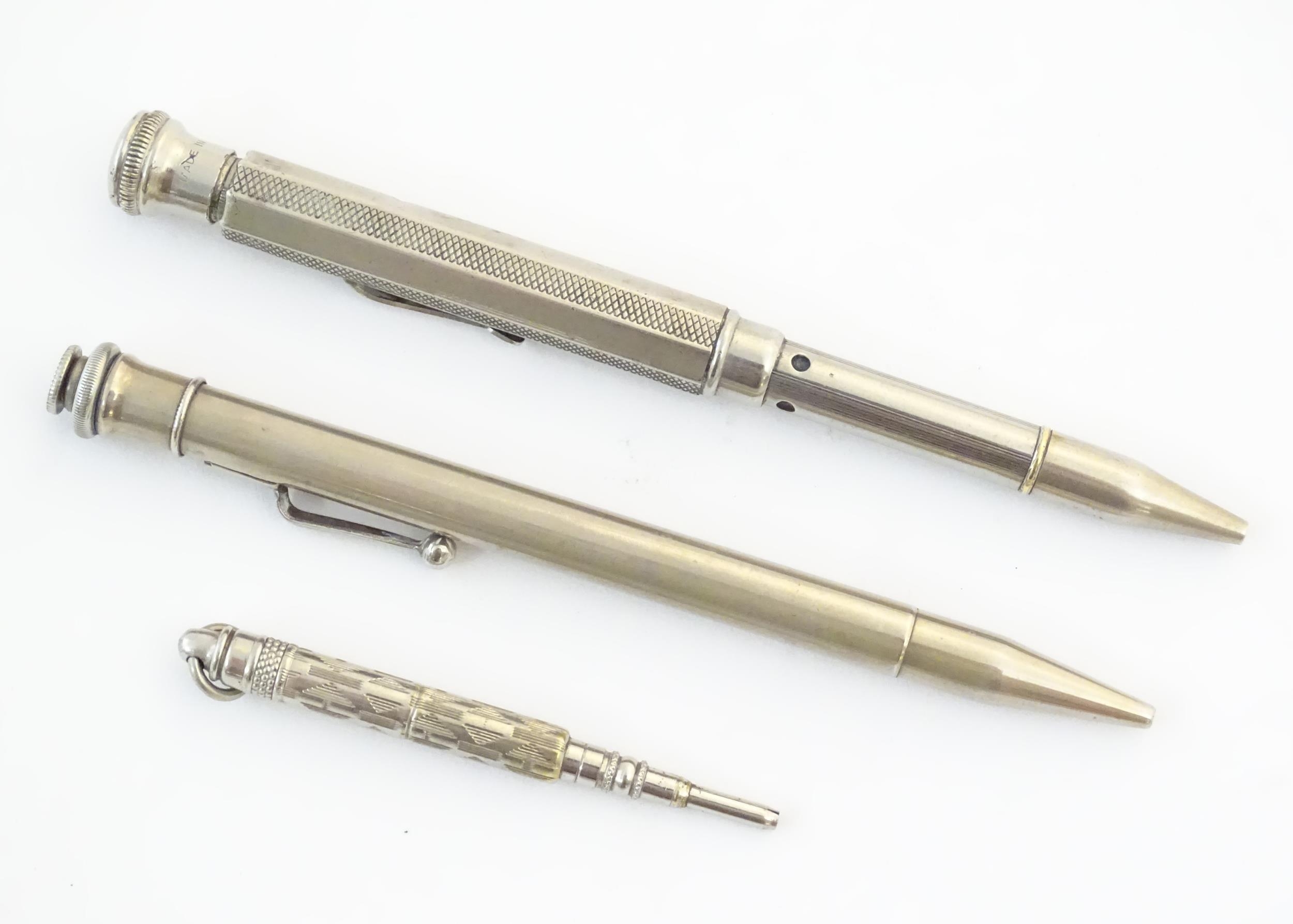 Two silver plate propelling pencils with provision for coloured leads, the other titled The Aladdin.