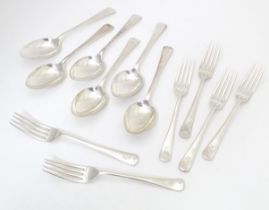 A set of six silver forks, together with a set of six silver spoons, all hallmarked London 1936,