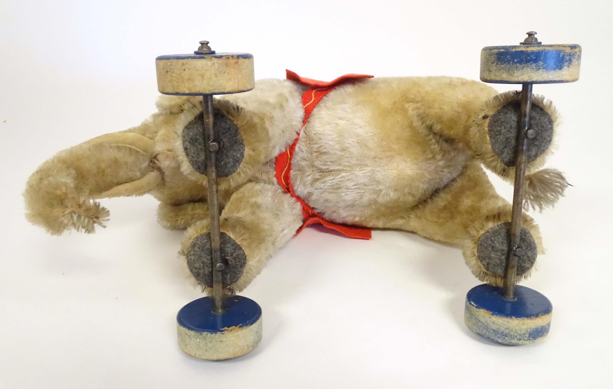 Toy: An early 20thC Steiff mohair pull along elephant toy with felt saddle, upon four wooden wheels, - Image 9 of 9