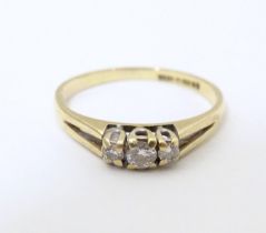 A 9ct gold ring set with trio of diamonds. Ring size approx N. Please Note - we do not make