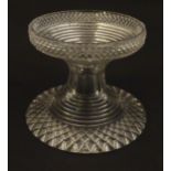 A 19thC cut glass pineapple stand with wide flared foot cut with a hobnail band rising to a