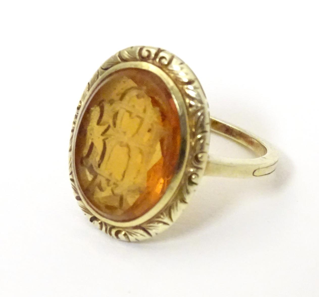 A late 19th / early 20thC yellow metal ring with engraved citrine seal to top depicting monogram. - Image 2 of 6