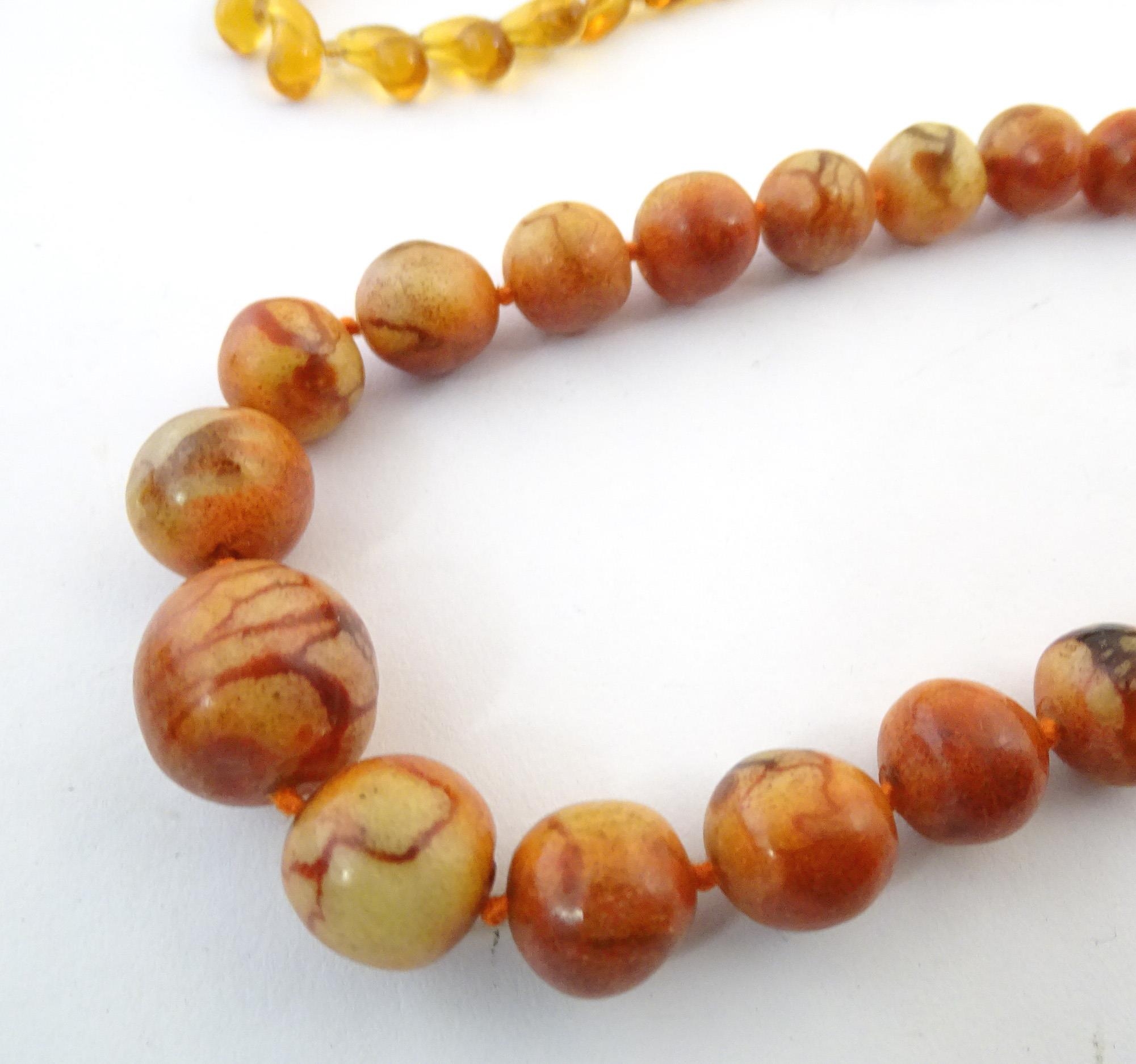 A quantity of assorted bead necklaces to include some amber examples. Please Note - we do not make - Bild 3 aus 16