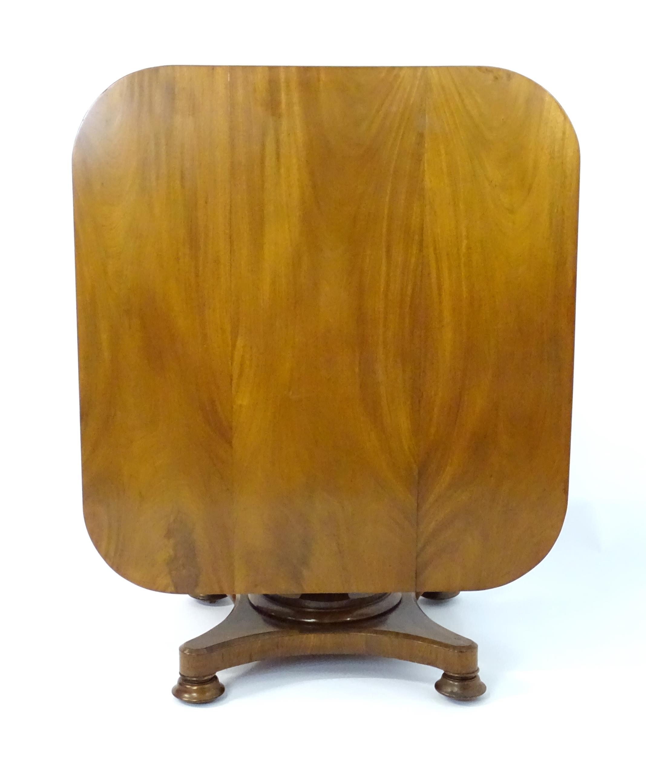 A Victorian mahogany tilt top table with rounded edges and standing on a pedestal base with - Image 3 of 8