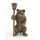 A novelty cold painted bronze model of a bear with a staff. Approx. 1 3/4" high Please Note - we