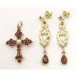 A 9ct gold pendant of cross shape set with garnets and pearl to centre. Together with a pair of