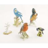 Four assorted models of birds to include a Goebel model of a Budgerigar, no. 3851218, a Goebel