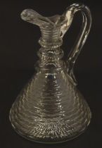A 19thC cut glass claret jug with facet cut detail and loop handle. 9" high Please Note - we do