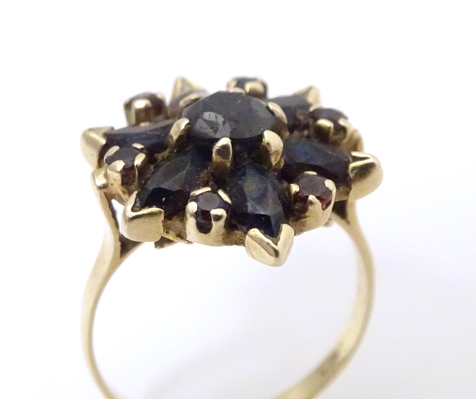 A 9ct gold ring set with garnets. Ring size approx R Please Note - we do not make reference to the - Image 4 of 7