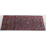 Carpet / Rug : A Mahal runner, the blue ground with floral motif decoration and red ground border.
