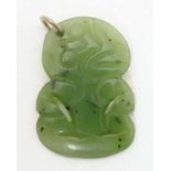 A New Zealand nephrite Maori pendant with carved detail. Approx 1 1/42 long Please Note - we do