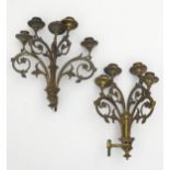 Two late 19th / early 20thC cast brass wall candelabras with scrolling floral and foliate