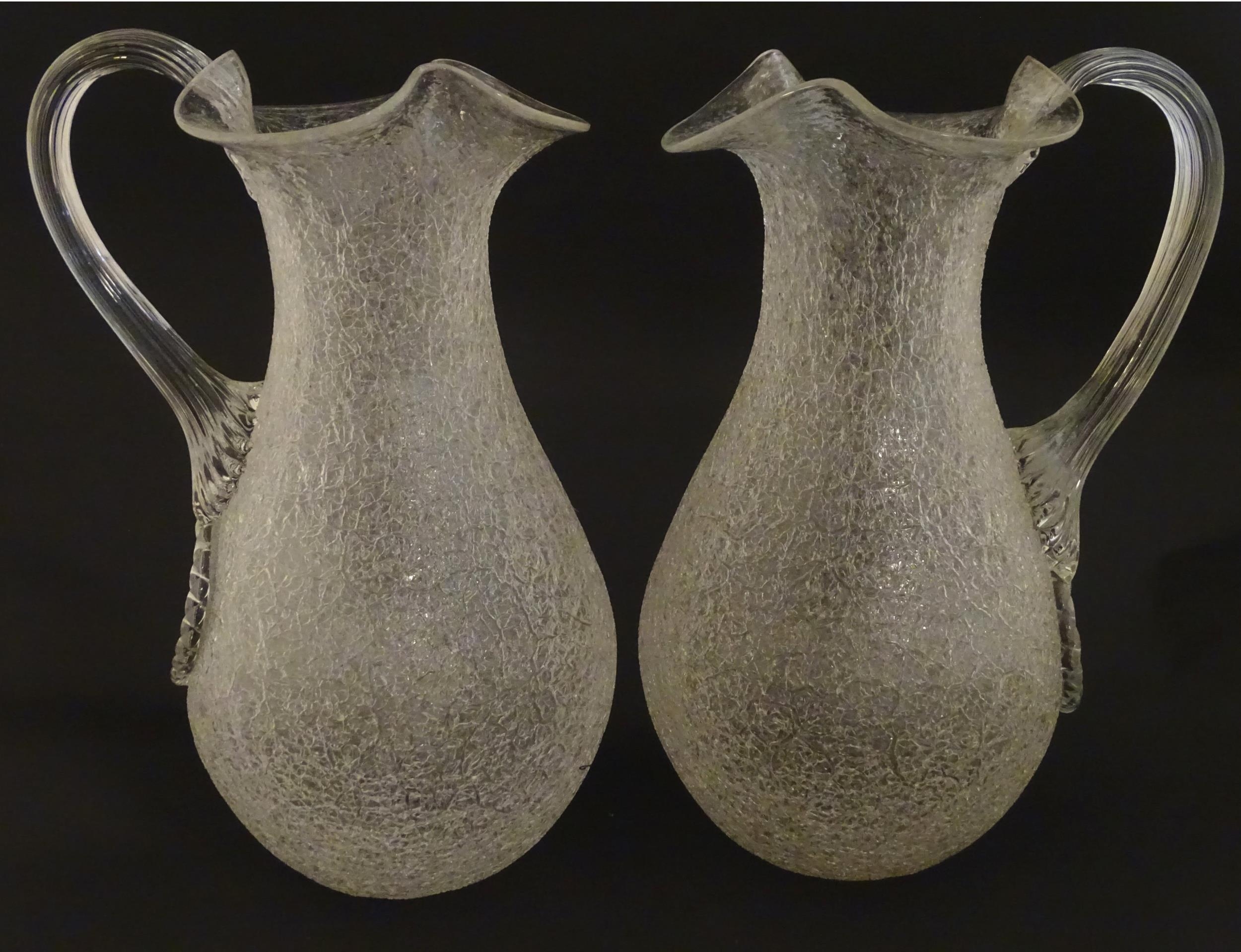 A pair of late 19thc / early 20thC lemonade / Kalte Ente jugs. The crackle glass jugs with loop