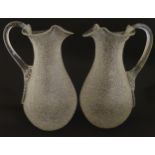 A pair of late 19thc / early 20thC lemonade / Kalte Ente jugs. The crackle glass jugs with loop