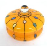 A Continental retro glass powder bowl with orange body and cover and painted detail, inspired by the