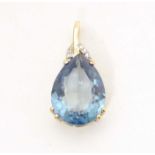 A 9ct gold pendant set with blue topaz and diamonds. Approx 1" long Please Note - we do not make