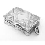 A Victorian silver vinaigrette with engraved decoration opening to reveal grille within,