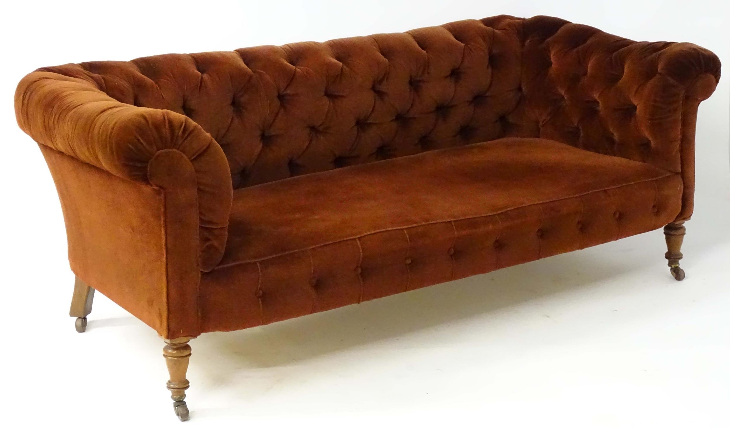 A late 19thC button back chesterfield sofa raised on turned tapering front legs. 81" wide x 37" deep - Image 2 of 5