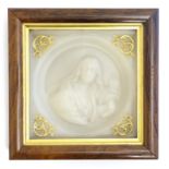 A 19thC wax tondo portrait depicting a woman holding a scroll. Ascribed and titled verso Womanhood