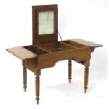 A mid 19thC campaign washstand, having retractable gadrooned legs that fold out, alongside a central