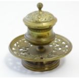A Victorian cast brass desk inkwell of pedestal form with pierced foliate base. Approx. 4 3/4"