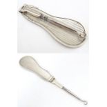 A silver folding button hook / shoe horn, hallmarked London 1927, importer Israel Segalov. Approx.