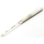 A folding silver fruit knife with mother of pearl handle. Hallmarked Sheffield 1912 maker Harrison