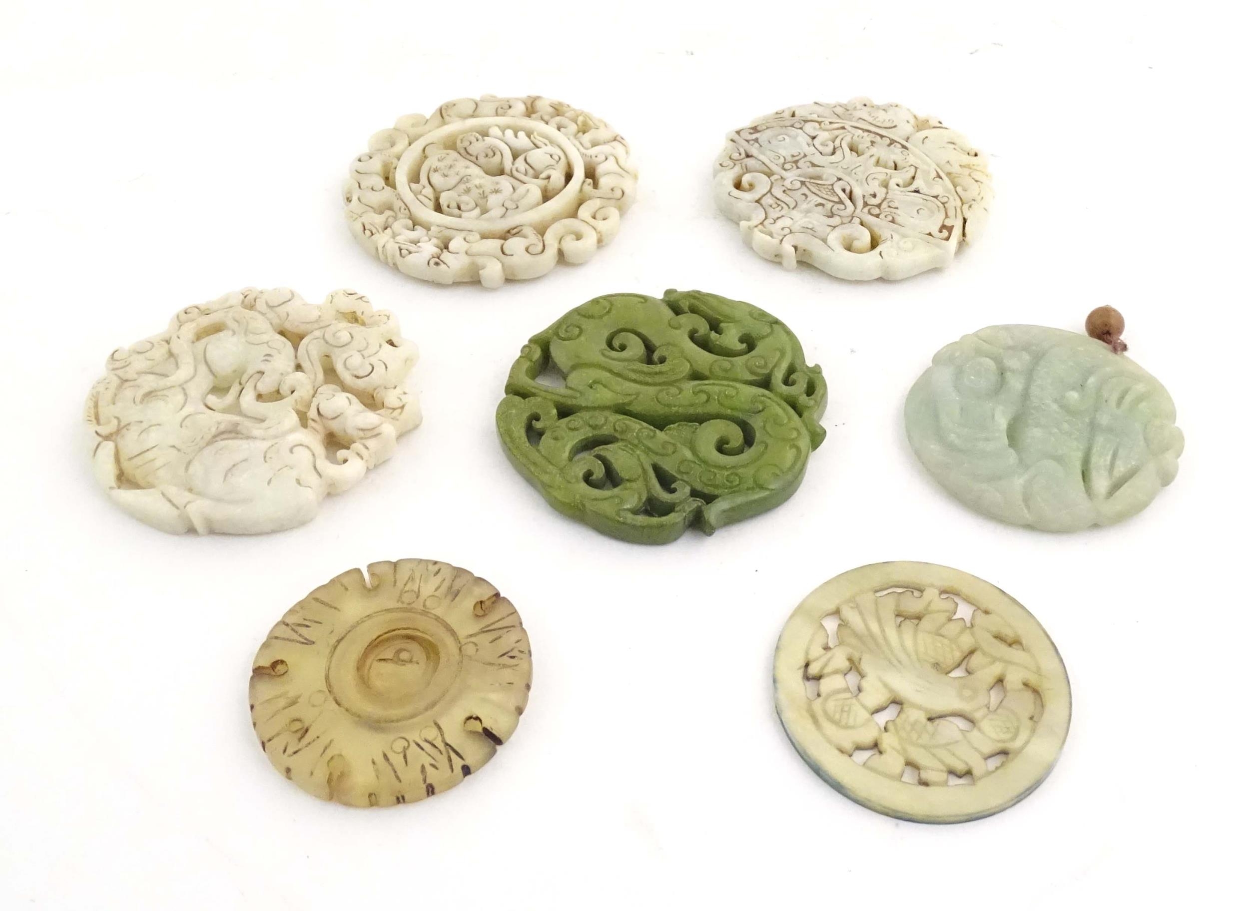 Seven assorted carved Oriental roundels / pendants, detail to include dragons, birds, stylised rams, - Image 3 of 4