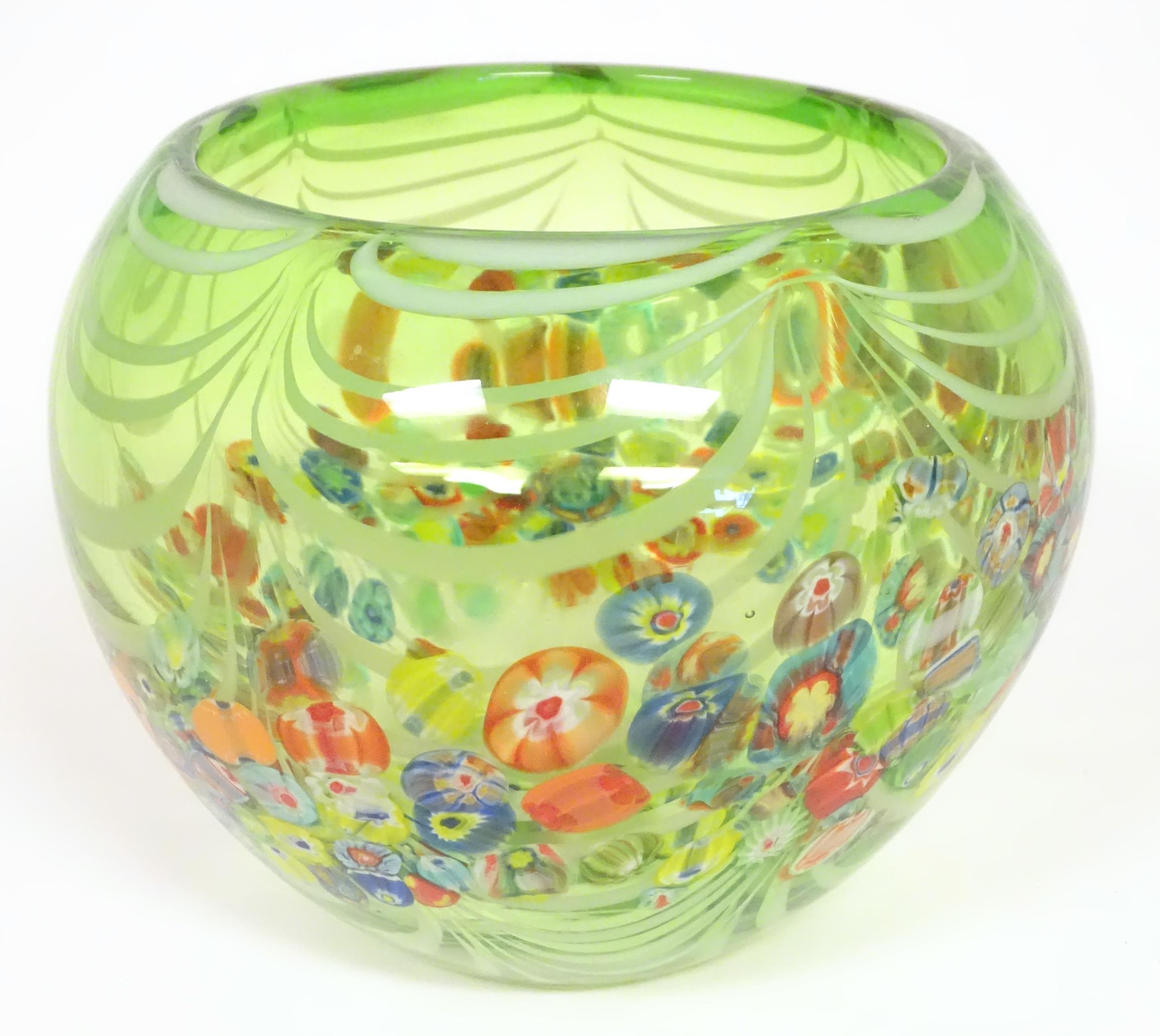 A green glass bowl with millefiori style decoration. Approx 7 1/2" high x 9" wide Please Note - we