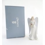 A Lladro figure modelled as an angel with a box of stars, Angelic Star, model no. 8534. Marked
