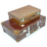 A mid 20thC 'Revelation' suitcase, with affixed transit labels, together with a small leather