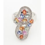 A 18ct white gold dress ring set with various coloured stones. Ring size approx. N 1/2 Please Note -