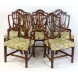 A set of eight late 18thC mahogany dining chairs in the Hepplewhite style with shield shaped backs