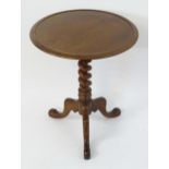 A late 19thC mahogany tripod table, having a dished top above a spiral turned column and three