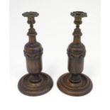 A pair of 19thC turned oak candlesticks with carved stylised swags and cast sconces. Approx. 12 1/4"