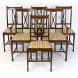 A set of six early 20thC mahogany dining chairs with cross braced backrests having reeded decoration
