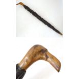 A 19thC cork oak walking stick, the shank with high ridged bark finish, the handle naively carved as